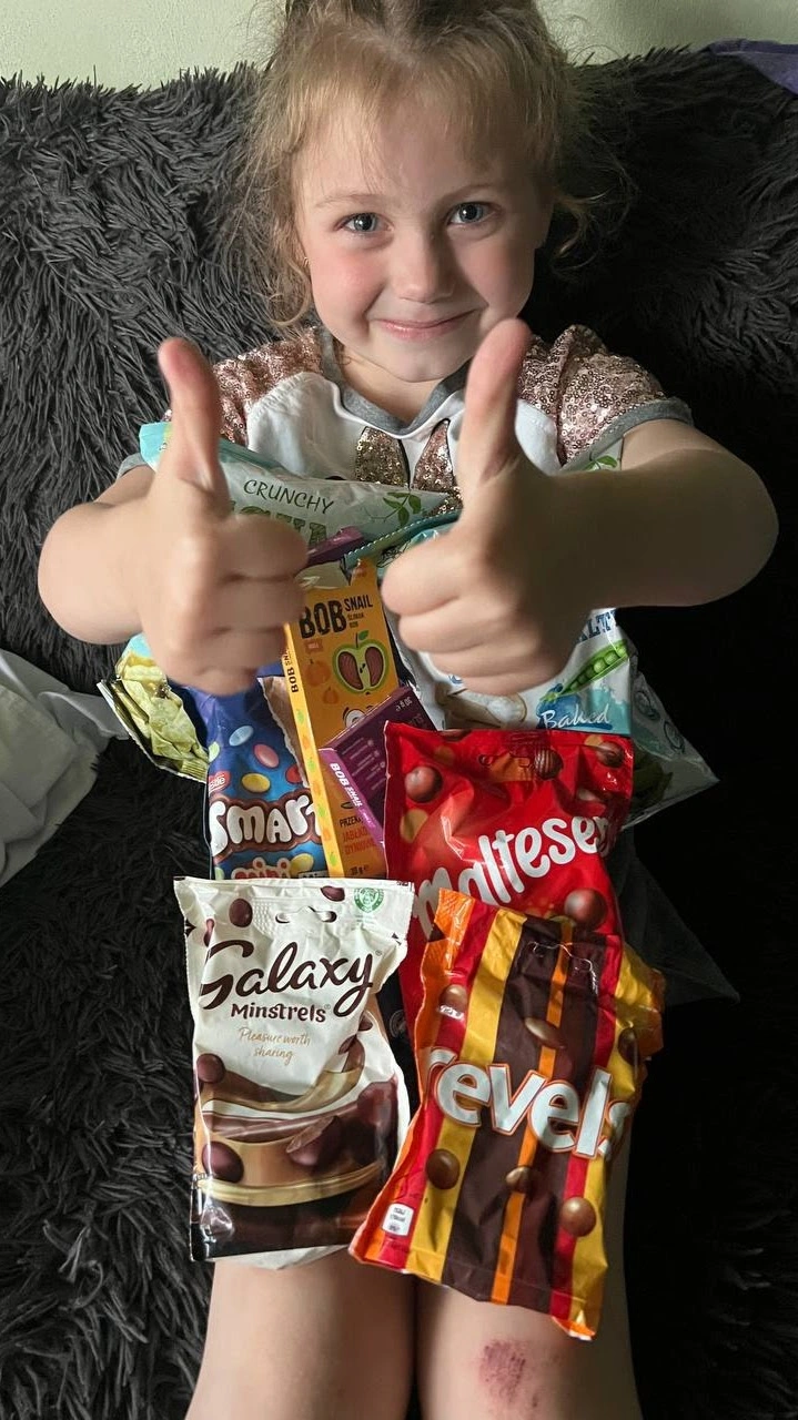 Kid receiving British snacks